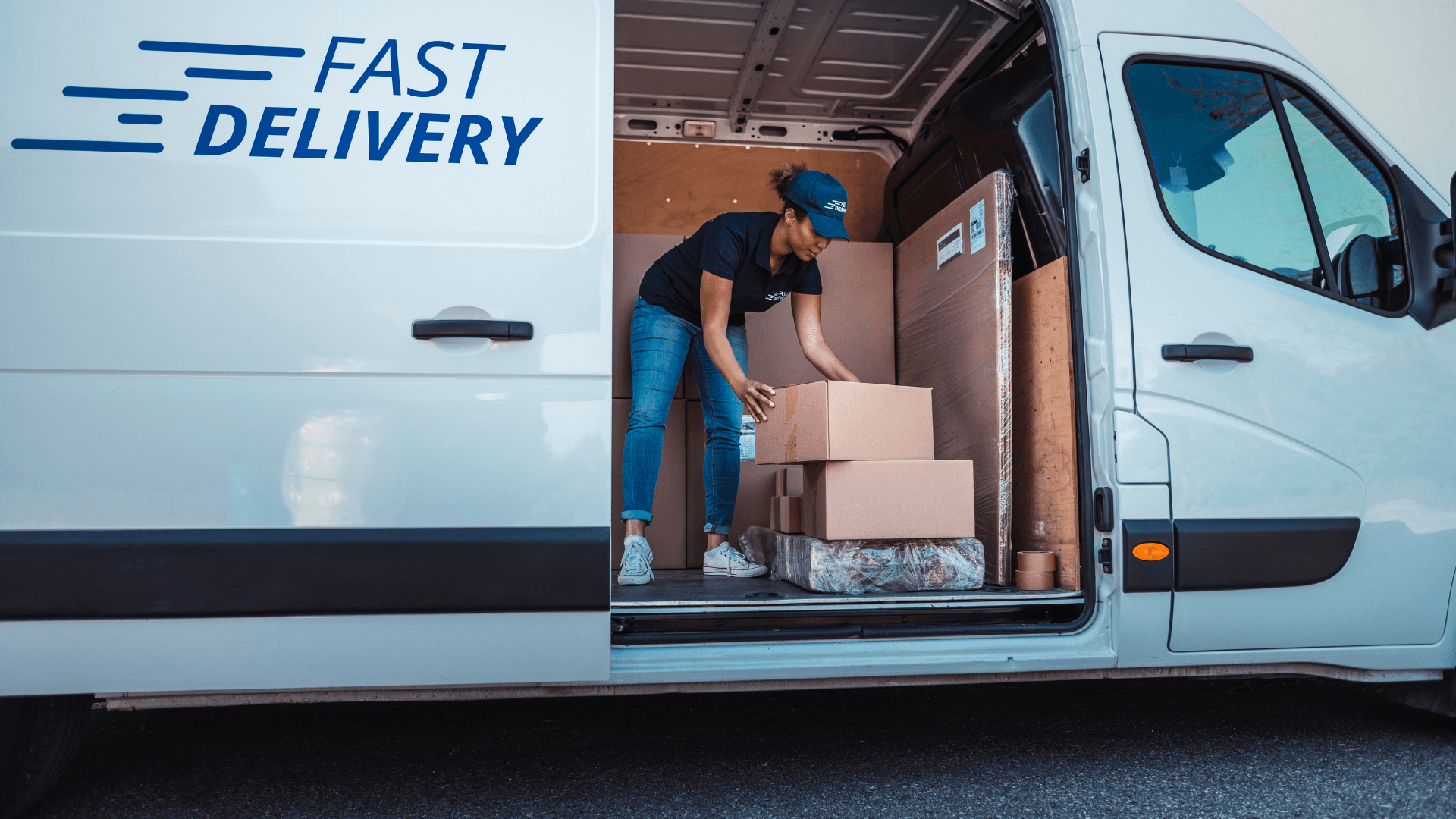 Courier loading express parcels into a delivery van for international shipping from Pakistan